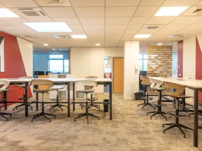 Aménagement Salle de Collaboration et Pose de Sols Rungis - AMSO AMSO : Aménagement d'une salle de collaboration moderne avec mobilier professionnel, revêtement de sol neuf et visuel mural (Menarini) pour les bureaux de Rungis.