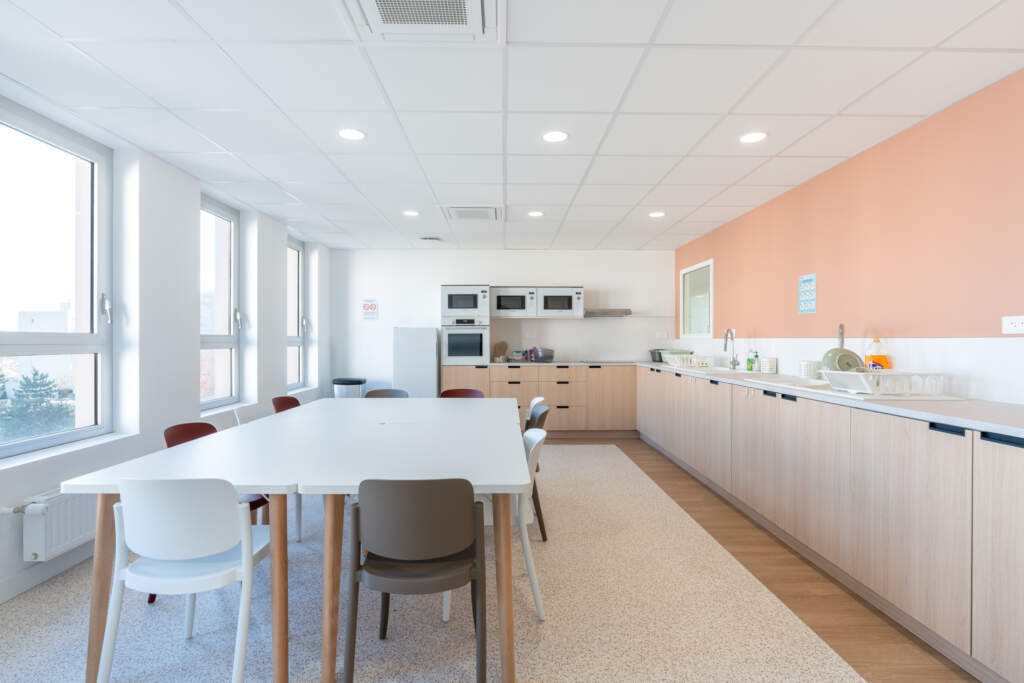 Bureau de thérapie avec fauteuils de couleur et placards de rangement sur mesure.